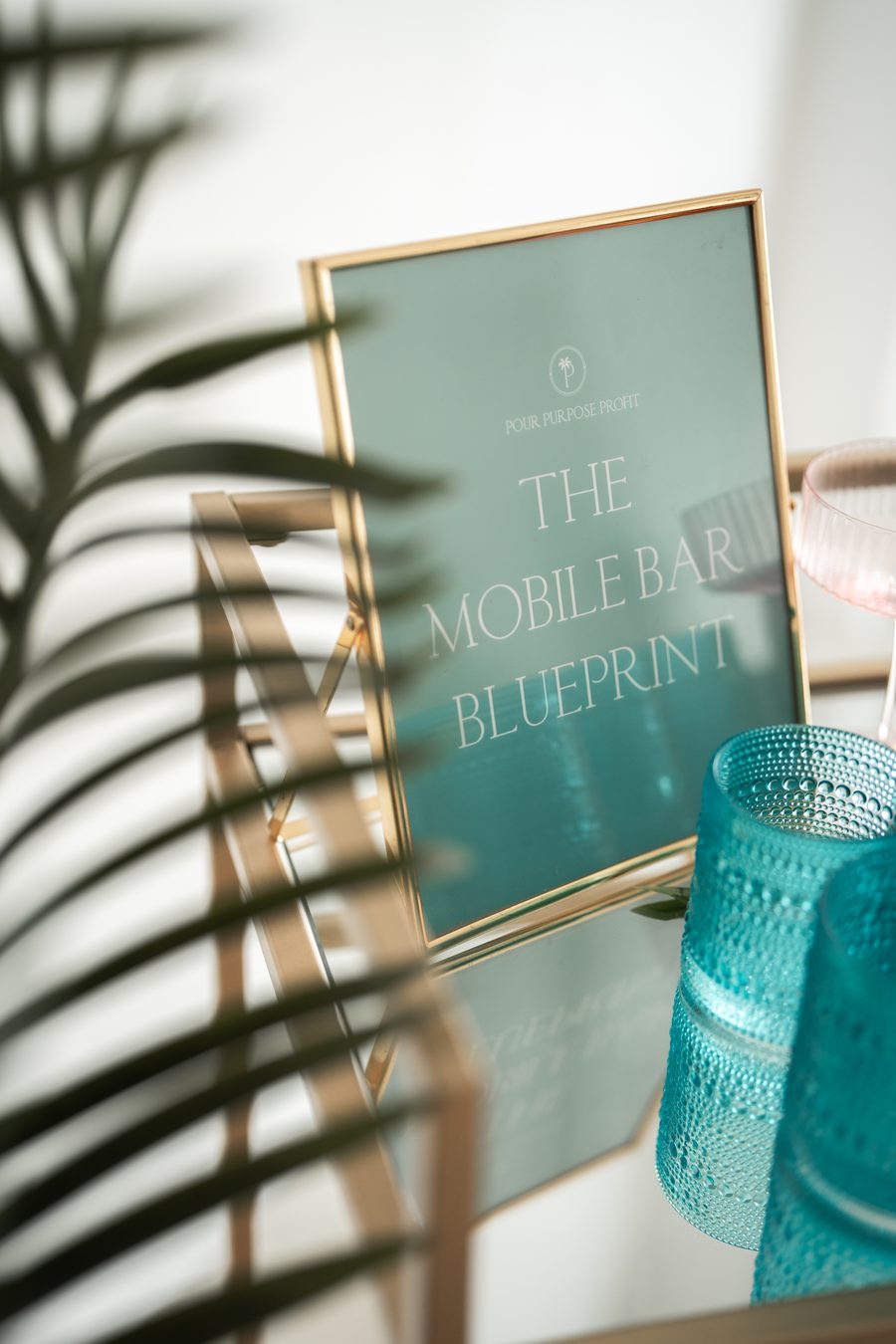 The Mobile Bar Blueprint sign styled on a bar cart