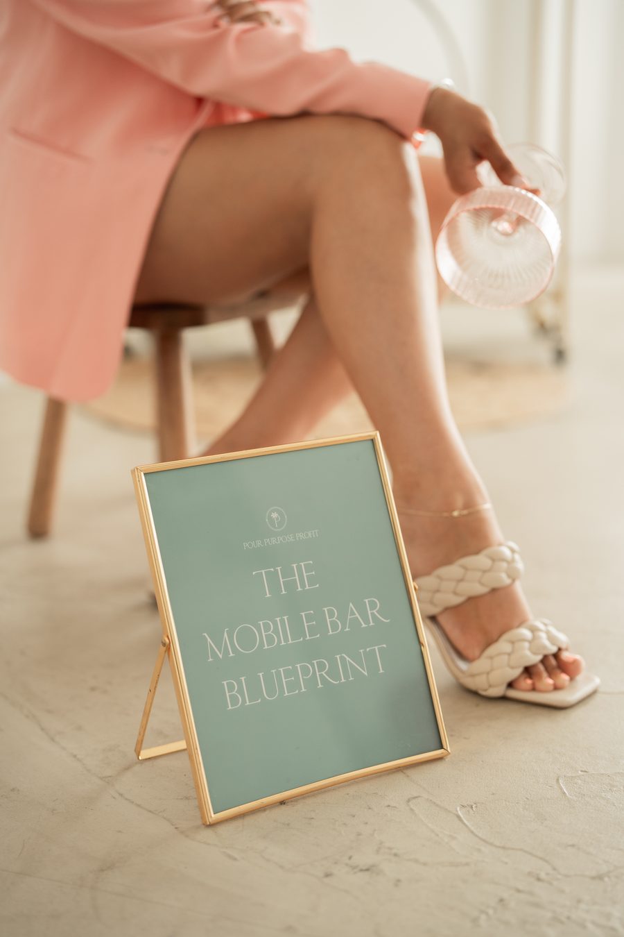 Marisa Zaremba seated beside The Mobile Bar Blueprint sign